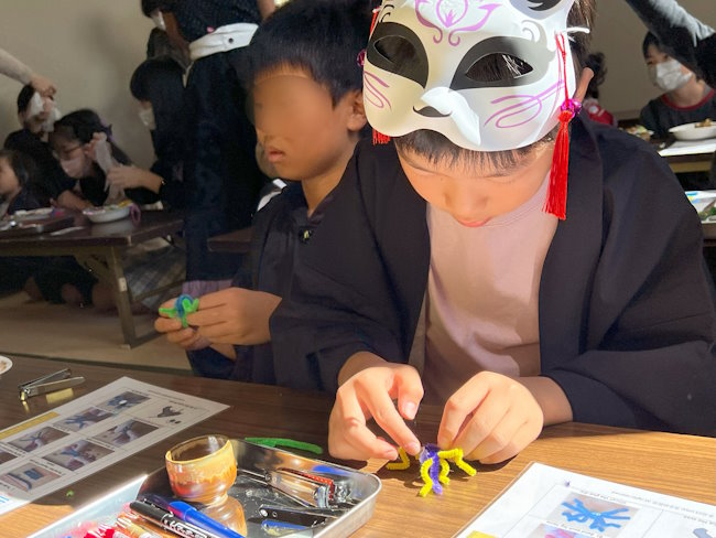 Students making Halloween crafts.