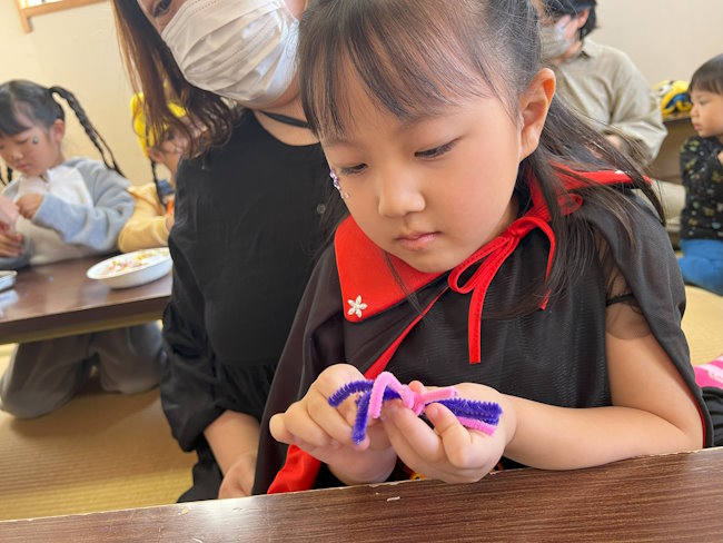 Students making Halloween crafts.