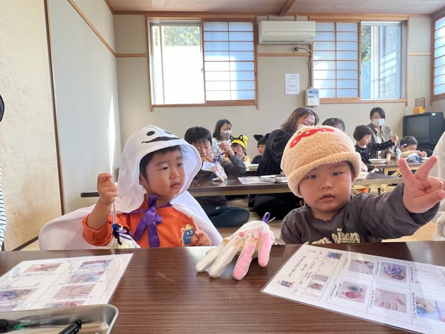 Students making Halloween crafts.