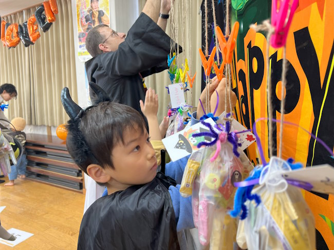 Students hanging Halloween crafts.
